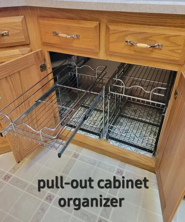 Pull-out wire baskets in an oak base cabinet, drawn out to show the contents